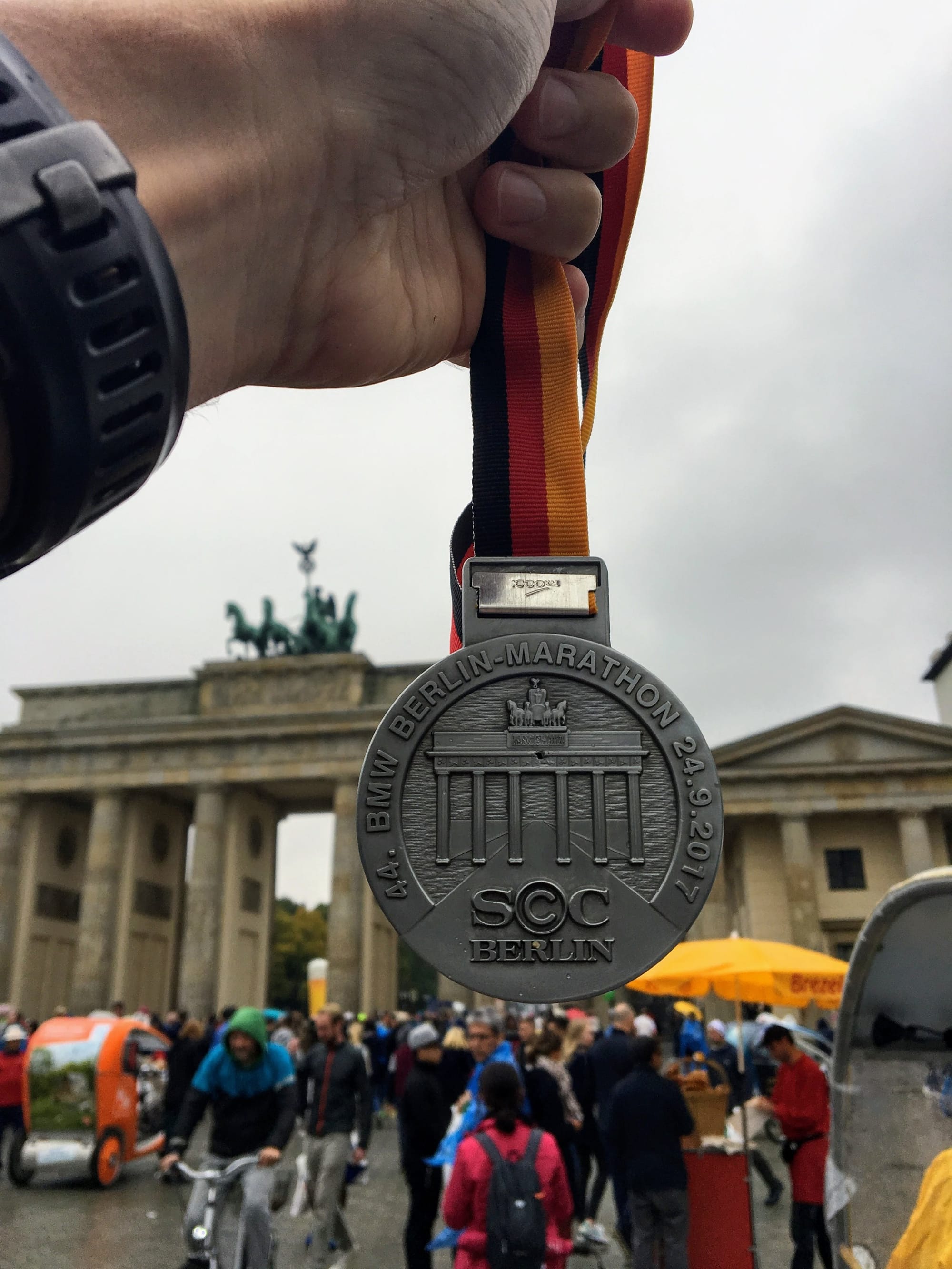 Berlin Marathon medal in front of Brandenburg gate